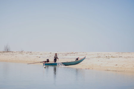 Fishermen in a boat on the beachの写真素材