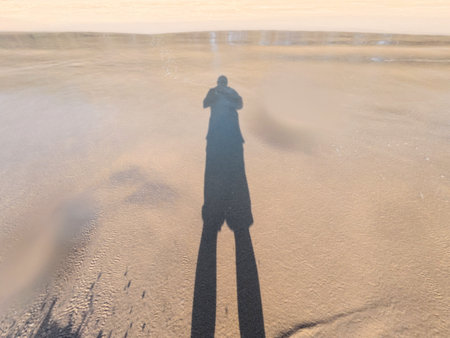 Silhouette of a man on the beach in the evening.