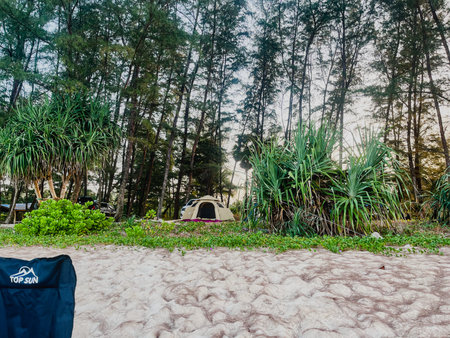 Camping on the beach with a tent and a backpackの写真素材