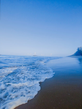 Baltic sea shore in a fog at sunrise. Poland, Europe.