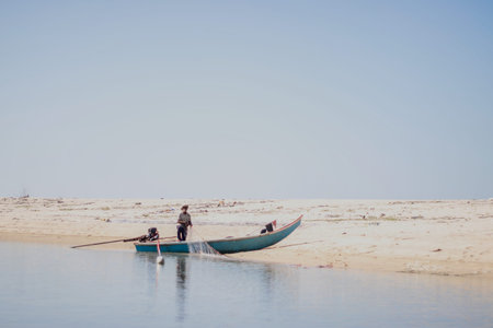 Fishermen in the boat on the beachの写真素材