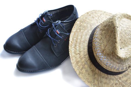 Dark blue shoes with straw hat isolated on white backgroundの写真素材
