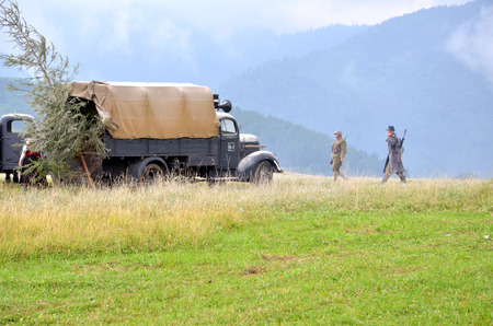 Strecno, Slovakia - July 21, 2012: Historical reenactment of World War 2 battle - armored transport vehicle  and soldiers dressed in german nazi uniformsのeditorial素材