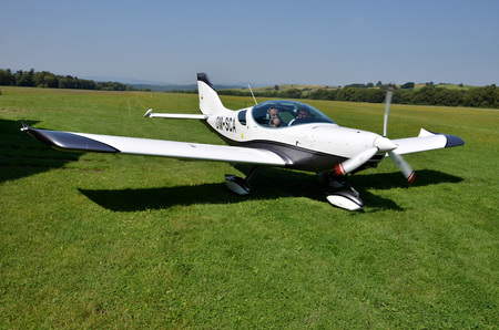 Ocova, Slovakia - August 2, 2014: Two men sit into ultralight propeller-driven airplane and get ready for taking offのeditorial素材