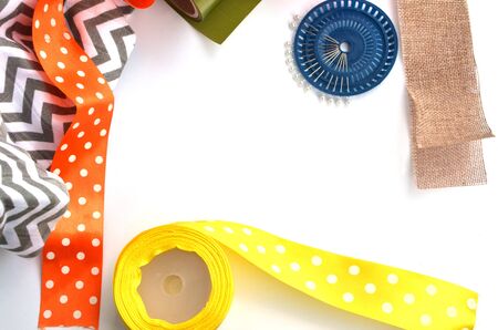 Bright color ribons and pins on white background, flat layの写真素材