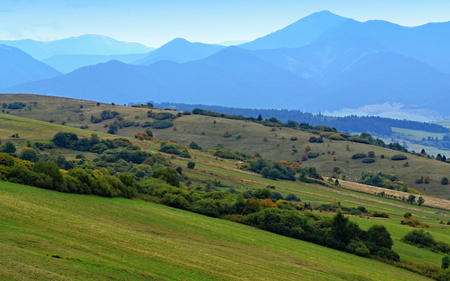 picturesque rural landscape with blue mountains in the backgroundの写真素材