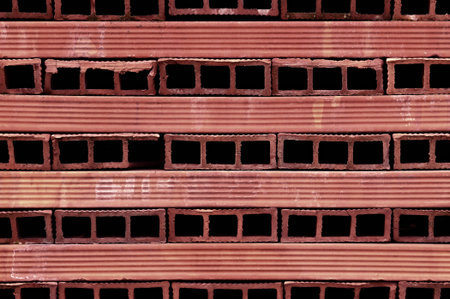 background or texture perforated red terracotta bricksの写真素材