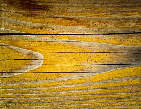 background or texture cracked yellow paint on boardの写真素材
