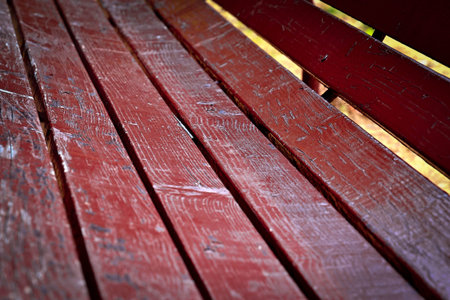 background detail of a wooden benches in the park burgundy colorの写真素材