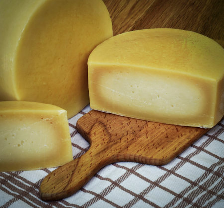 retro still life Round sliced hard cheese