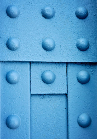background or texture blue Round iron rivets on the beam