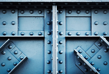 background or texture detail blue silver riveted girder railway bridgeの写真素材