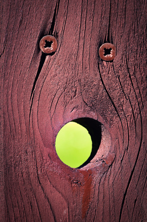 stylized facial expression on brown wooden boardの写真素材