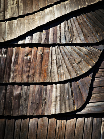 abstract background or texture Detail of wooden shingle roof with a tildeの写真素材