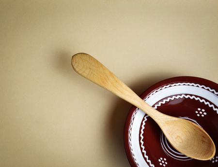 background a wooden spoon in a clay bowlの写真素材