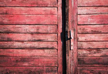 background or texture old red wooden door with handleの写真素材