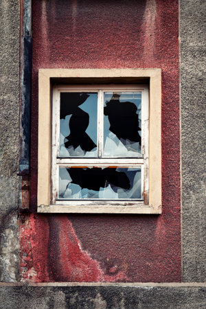 broken glass on the window of an old building