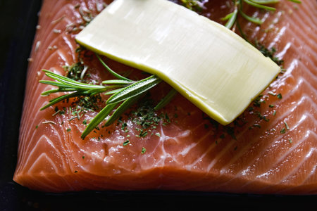 food background Salmon with butter and rosemaryの写真素材