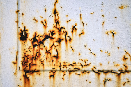 background cracked rusty surface of a white old sheet metalの写真素材