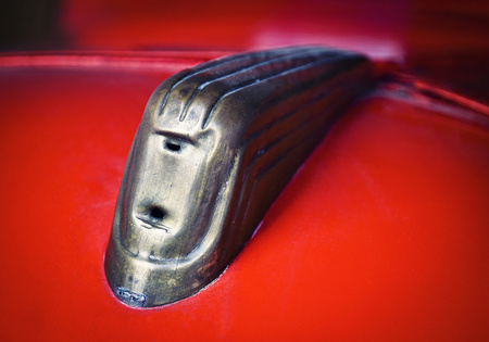 background detail of an ornament on an old red carの写真素材