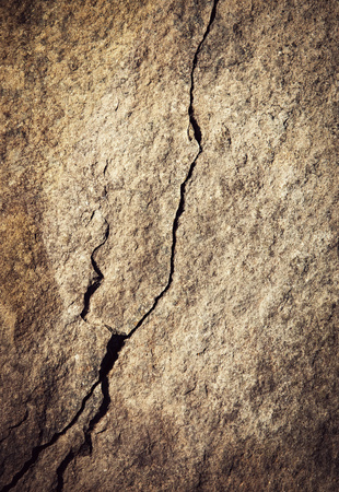 background or texture a minimalist crack on the rockの写真素材