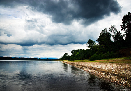 seasonal landscape background abandoned beach under cloudsの写真素材