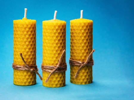 background three candles of yellow beeswaxの写真素材