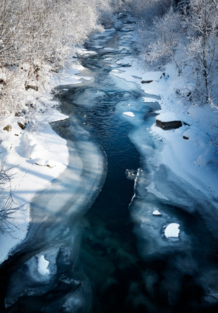 seasonal background winter frozen wavy riverの写真素材