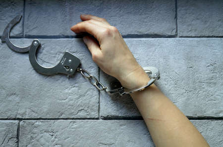 Image of womens hands in handcuffsの写真素材
