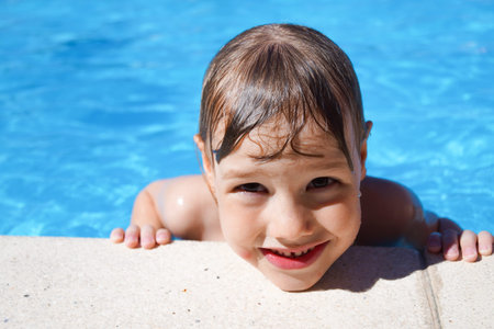 Charming girl in pool in the summer