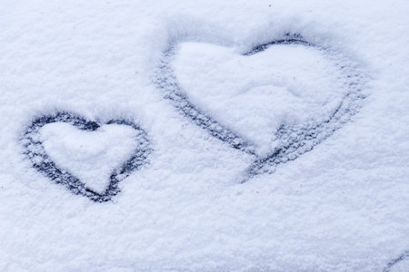 Images of a heart in the snow. Winter natural background.の写真素材