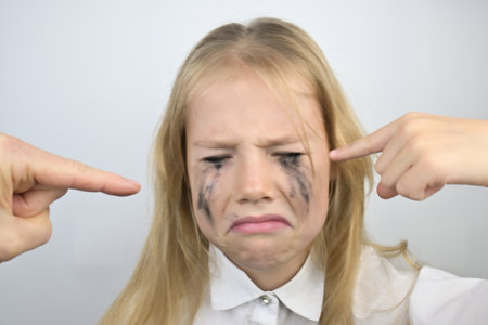 A little girl with brown disheveled hair on a white background.の写真素材