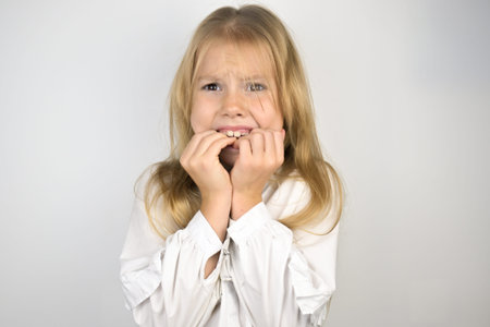 A little girl with blonde hair on a white background.