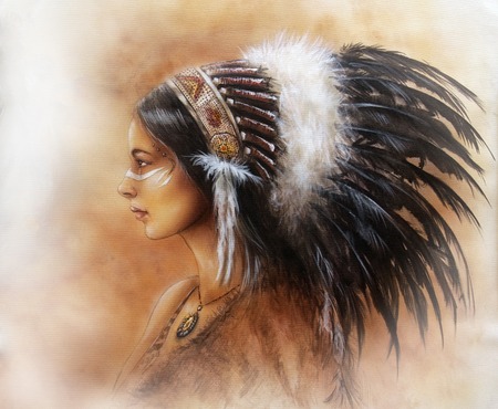 young indian woman wearing a big feather headdress, a profile portrait on structured abstract backgroundの写真素材