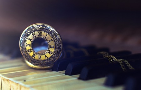 Vintage piano keys with antique pocket watch  time concept.の写真素材