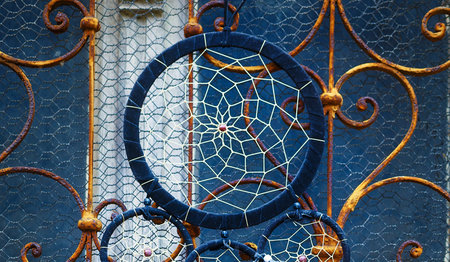 Color feathers . Dream Catcher and ornamental  window on background.