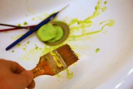 Cleaning Paint brushes in the sink by color.の写真素材