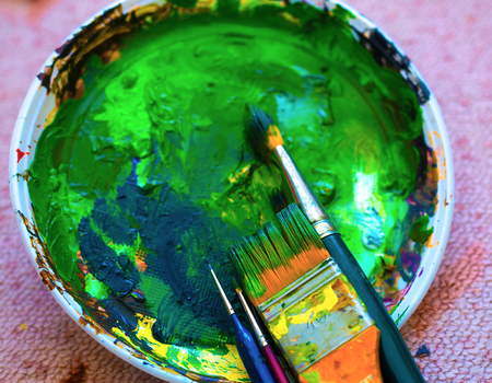 Paint brushes to the painting palette with colors. on the carpet.の写真素材