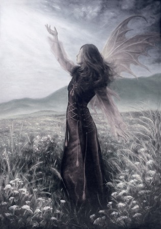 painting fairy woman in a historic dress standing in rays of sunlight amids a wild meadow Color effectの写真素材