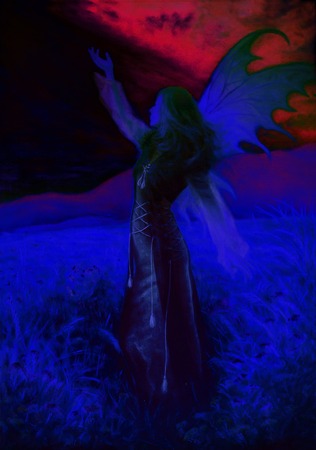 painting fairy woman in a historic dress standing in rays of sunlight amids a wild meadow Color effectの写真素材