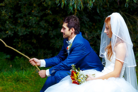 bride and groom fishing together - romantic wedding concept