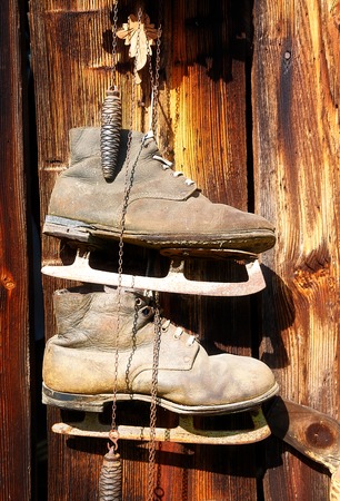 antique old style retro object assemblage on a wooden wall, rustic stile. Old skatesの写真素材