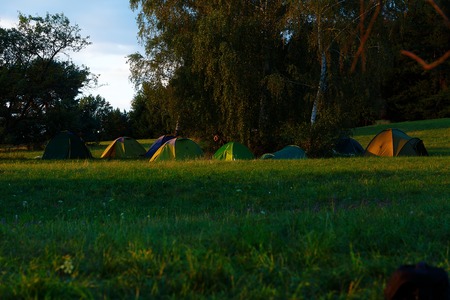 couple of tents standing together on beautiful wild summer meadowの写真素材