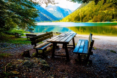 Beautiful landscape. Wooden bench overlooking the lake and mountainsの写真素材