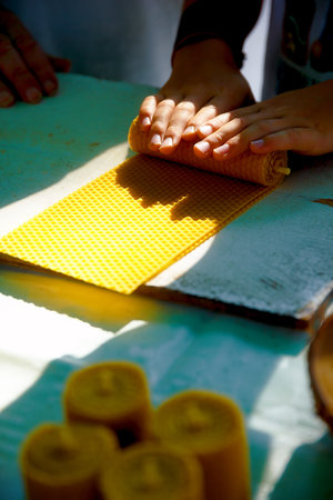 making candle from honey bee wax plate at market