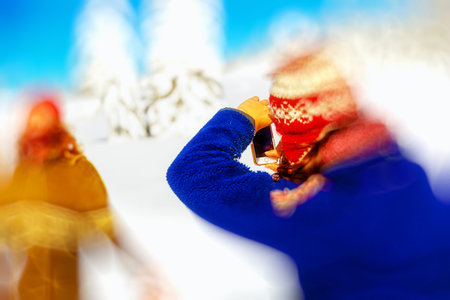 Girl photo of a man in a beautiful mountain snowy landscape. Blur effect