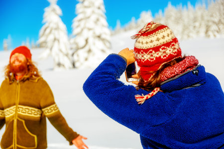 Girl photo of a man in a beautiful mountain snowy landscapeの写真素材