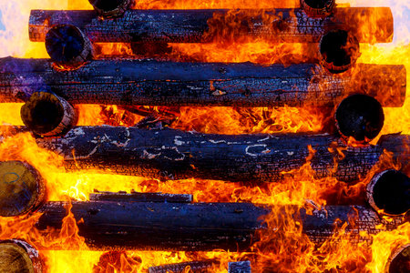 beautiful structure of burning logs and flames of great bonfire.の写真素材