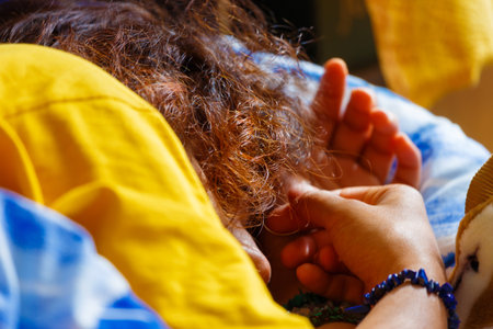 Detail of sleeping woman with red hair.