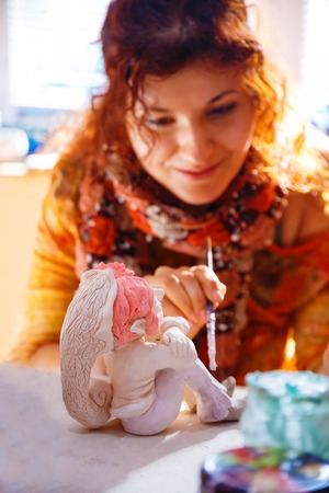 yong Woman making a dwarf figure. Creative concept.の写真素材